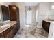 Elegant bathroom features double sinks, granite countertops, and dark wood cabinetry at 4162 Roberts Crest Dr, Suwanee, GA 30024