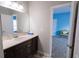 Bathroom with a dark vanity, light countertops, large mirror, and view to another bedroom at 4162 Roberts Crest Dr, Suwanee, GA 30024