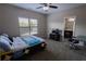 Bedroom features a ceiling fan, a window and a bed with a colorful cover at 4162 Roberts Crest Dr, Suwanee, GA 30024