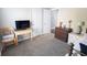 Bedroom area showcasing neutral walls and carpet, with wooden furniture pieces at 4162 Roberts Crest Dr, Suwanee, GA 30024