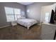 Cozy bedroom with large window, neutral decor, and plush carpet flooring at 4162 Roberts Crest Dr, Suwanee, GA 30024
