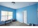 A blue bedroom with a writing desk and a rocking horse next to a window at 4162 Roberts Crest Dr, Suwanee, GA 30024