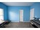 A bright blue bedroom with a writing desk, rocking horse, and keyboard in the corner at 4162 Roberts Crest Dr, Suwanee, GA 30024