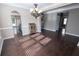 Open dining room with dark wood floors, decorative chandelier and lots of light at 4162 Roberts Crest Dr, Suwanee, GA 30024