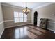 Dining area with dark hardwood floors, neutral paint, and elegant chandelier at 4162 Roberts Crest Dr, Suwanee, GA 30024