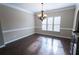 Dining room with hardwood floors and neutral paint, features a modern chandelier at 4162 Roberts Crest Dr, Suwanee, GA 30024