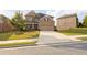 Charming two-story brick home with manicured lawn and a spacious driveway leading to a two car garage at 4162 Roberts Crest Dr, Suwanee, GA 30024