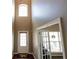 Grand foyer with soaring ceilings, gleaming hardwood floors, and a view into the adjacent living area through glass doors at 4162 Roberts Crest Dr, Suwanee, GA 30024