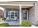 Charming front porch with brick accents, stylish seating, and a decorative wreath adorning the inviting front door at 4162 Roberts Crest Dr, Suwanee, GA 30024