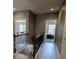 Upstairs hallway featuring wood-look floors and decorative railings at 4162 Roberts Crest Dr, Suwanee, GA 30024
