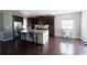 Open kitchen features stainless appliances, granite counters, center island, and hardwood floors at 4162 Roberts Crest Dr, Suwanee, GA 30024