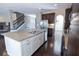 Spacious kitchen with granite countertops, stainless steel appliances, a large island, and dark hardwood floors at 4162 Roberts Crest Dr, Suwanee, GA 30024