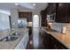 Modern kitchen with granite countertops, stainless steel appliances, ample cabinetry, and dark wood flooring at 4162 Roberts Crest Dr, Suwanee, GA 30024