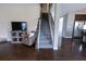 Open-concept living room featuring a staircase, tv, and hardwood flooring at 4162 Roberts Crest Dr, Suwanee, GA 30024
