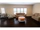 Spacious living room with hardwood floors, many windows, and comfortable seating at 4162 Roberts Crest Dr, Suwanee, GA 30024