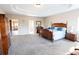 Large primary bedroom boasts carpet floors, tray ceiling, and ensuite at 4162 Roberts Crest Dr, Suwanee, GA 30024