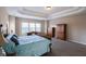 Expansive main bedroom featuring tray ceilings, plush carpeting, and bright natural light at 4162 Roberts Crest Dr, Suwanee, GA 30024