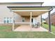 Covered patio with an outdoor dining set and a view of the landscaped backyard at 4162 Roberts Crest Dr, Suwanee, GA 30024