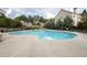 Community pool with ample seating surrounded by manicured landscaping and neighborhood homes at 4162 Roberts Crest Dr, Suwanee, GA 30024