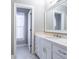 Bright bathroom featuring a white vanity, marble countertops, and a large mirror at 12 Candler Grove Dr, Decatur, GA 30030