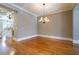 Dining room featuring hardwood floors, decorative lighting, neutral walls, and a view into the kitchen at 12 Candler Grove Dr, Decatur, GA 30030
