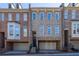 Stylish townhouse with brick and stone facade, a front-entry garage, and a classic multi-pane window design at 12 Candler Grove Dr, Decatur, GA 30030