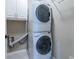 Laundry room featuring a stacked washer and dryer and cabinet storage space at 12 Candler Grove Dr, Decatur, GA 30030