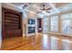 Bright living room featuring hardwood floors, a fireplace flanked by bookshelves, and large windows for ample natural light at 12 Candler Grove Dr, Decatur, GA 30030