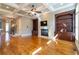 Living room with a coffered ceiling, a fireplace, built-in bookshelves, and hardwood floors for an elegant feel at 12 Candler Grove Dr, Decatur, GA 30030