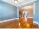 Open-concept living space showing hardwood floors, blue walls, and a staircase leading to the upper level at 12 Candler Grove Dr, Decatur, GA 30030