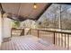 The back deck features stained wood and a partial awning to keep you cool on sunny days at 2033 Old Newnan Rd, Carrollton, GA 30116