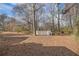 Expansive backyard with mature trees and a raised deck, perfect for outdoor activities at 2033 Old Newnan Rd, Carrollton, GA 30116