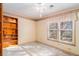 Empty bedroom with carpeted floors, a built-in bookcase, and large windows providing plenty of natural light at 2033 Old Newnan Rd, Carrollton, GA 30116