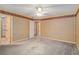 Spacious bedroom with neutral wallpaper, carpeted floors, and multiple doorways at 2033 Old Newnan Rd, Carrollton, GA 30116