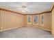 Empty bedroom with carpet, neutral striped wallpaper, and a bay window at 2033 Old Newnan Rd, Carrollton, GA 30116