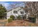 Charming two-story home with well-maintained landscaping, mature trees, and a welcoming front entrance at 2033 Old Newnan Rd, Carrollton, GA 30116