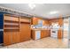 Traditional-style kitchen features wood cabinets, white appliances, and a spacious layout with built in storage at 2033 Old Newnan Rd, Carrollton, GA 30116