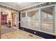 View of a living room with large windows, patterned floor, and an adjacent room with a fireplace at 2033 Old Newnan Rd, Carrollton, GA 30116