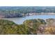 A scenic aerial view of a serene lake bordered by lush trees, creating a peaceful natural retreat at 4374 Westside Nw Dr, Acworth, GA 30101