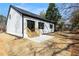 Rear view of a bright home with a backyard, patio area, and wooden stairs at 4374 Westside Nw Dr, Acworth, GA 30101