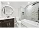 Modern bathroom with marble tiled wall, dark vanity with white sink and an oval mirror at 4374 Westside Nw Dr, Acworth, GA 30101