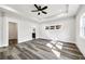 Brightly lit main bedroom with ceiling fan and stylish floor and tray ceiling at 4374 Westside Nw Dr, Acworth, GA 30101