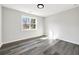 Bright bedroom featuring sleek dark-tone wood flooring, and a sun-filled window at 4374 Westside Nw Dr, Acworth, GA 30101
