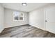 Bedroom showcasing a window letting in light and hardwood floors and white trim at 4374 Westside Nw Dr, Acworth, GA 30101