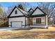 Charming new construction home with a covered porch, craftsman details, and an attached garage at 4374 Westside Nw Dr, Acworth, GA 30101
