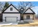 New craftsman-style home with black trim, a covered porch, and an attached garage at 4374 Westside Nw Dr, Acworth, GA 30101