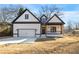 Charming new construction home with a covered porch, craftsman details, and an attached garage at 4374 Westside Nw Dr, Acworth, GA 30101