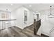 Upstairs hallway with wood and metal railings and modern lighting fixtures at 4374 Westside Nw Dr, Acworth, GA 30101