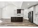 Open concept kitchen featuring a center island, modern appliances, and white and dark cabinetry at 4374 Westside Nw Dr, Acworth, GA 30101