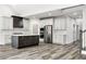 Well-lit kitchen features stainless appliances and a large island for food preparation at 4374 Westside Nw Dr, Acworth, GA 30101